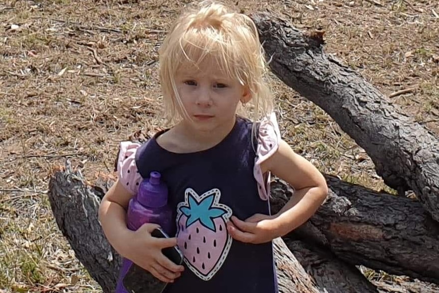 Ruby, 2, holding a water bottle.