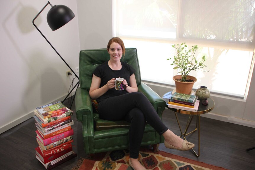 Liz Fitzgerald sits in an armchair in her living room