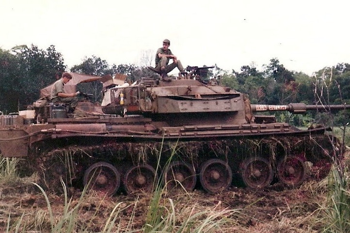 An army tank with men sitting on it in Vietnam in 1971.