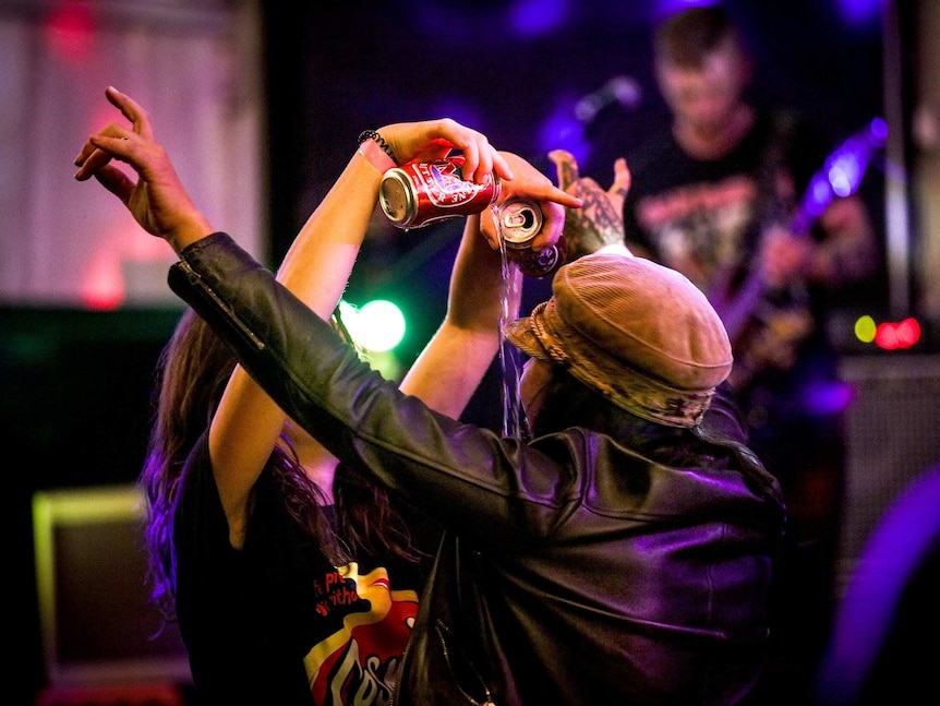 Women celebrate by pouring beer on the dancefloor