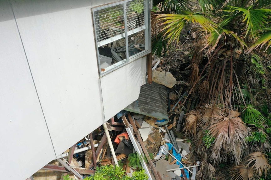 A damaged garden behind a house