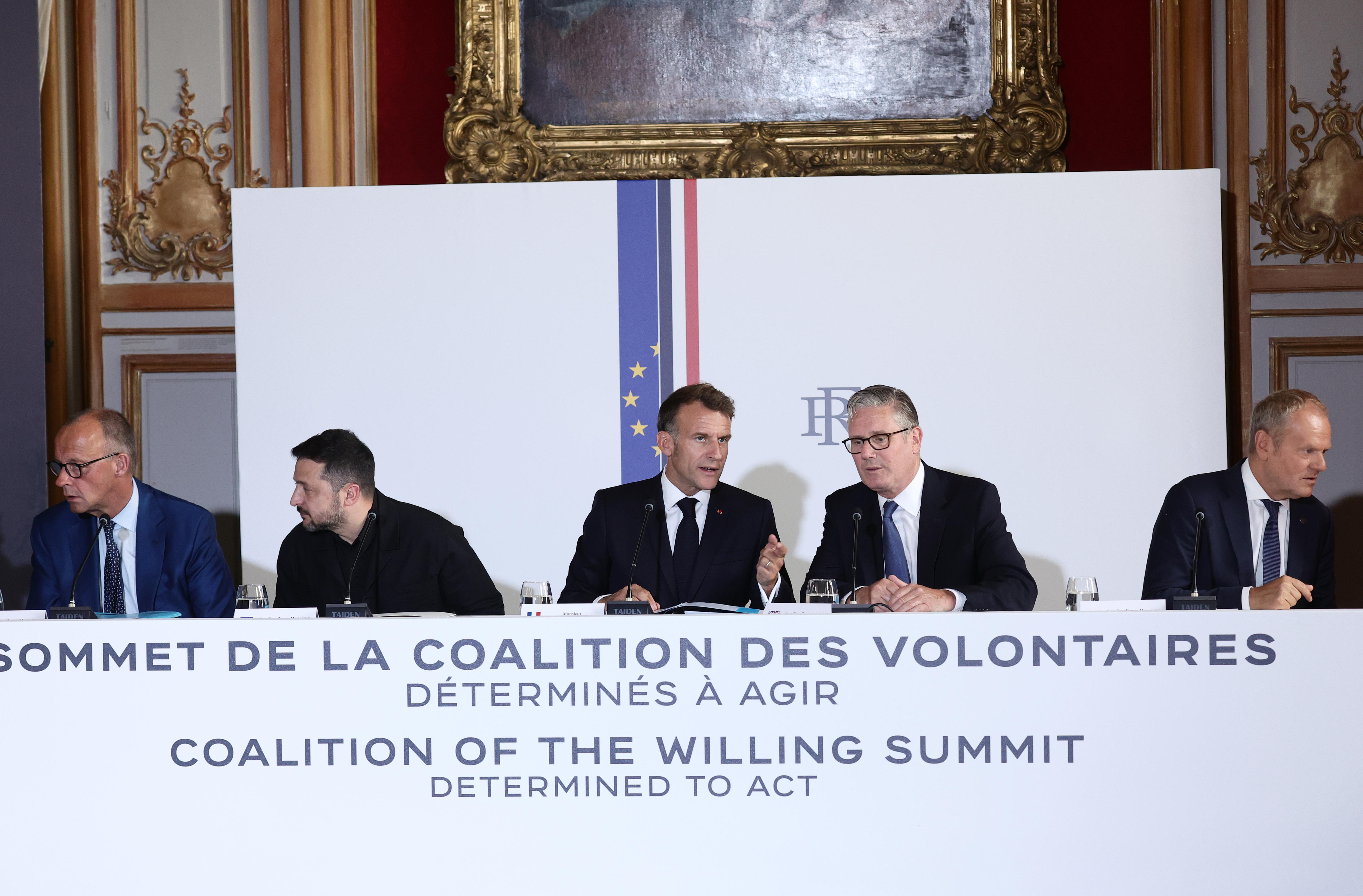 A group of male poiticians in suits at a meeting