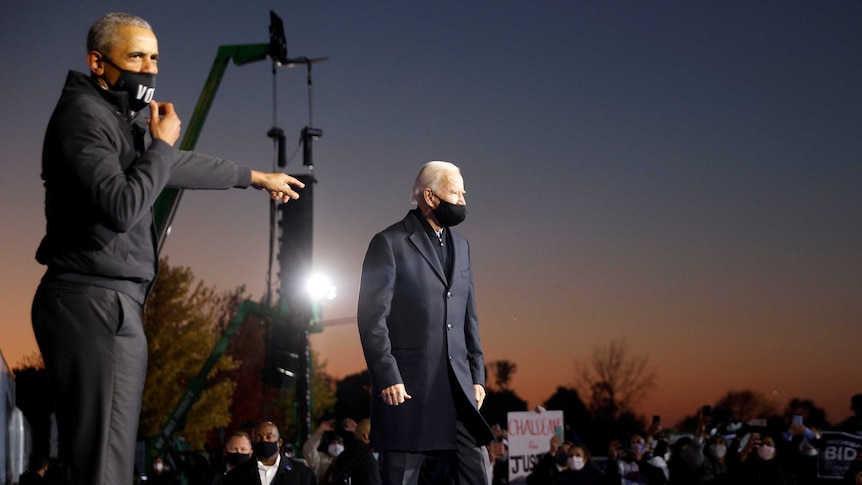 Barack Obama points at US presidential candidate Joe Biden during an election campaign rally.