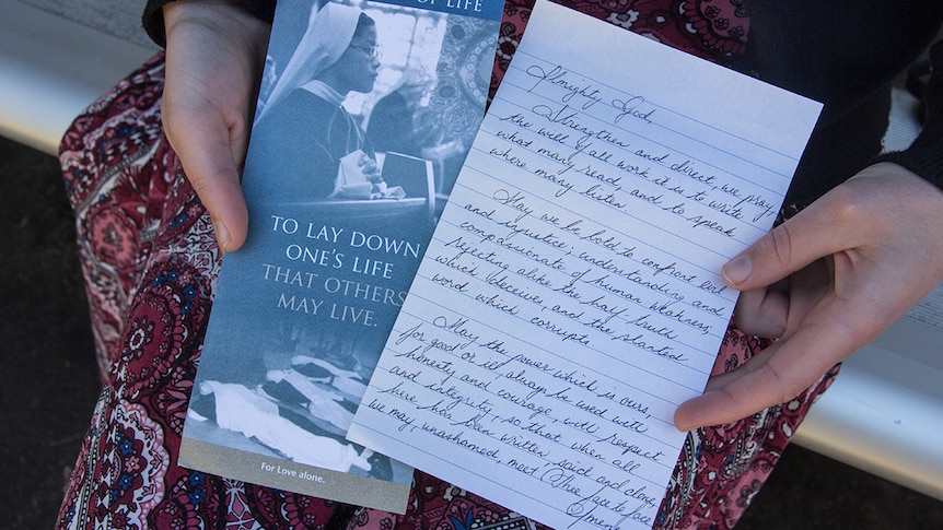 Nancy Webb holds the leaflet she was handed for Sisters of Life and a prayer she wrote.
