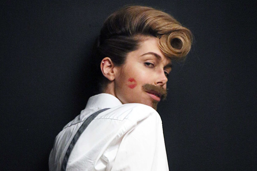 Tara Moss appears in a shirt and moustache as 'Victor Lamour'.