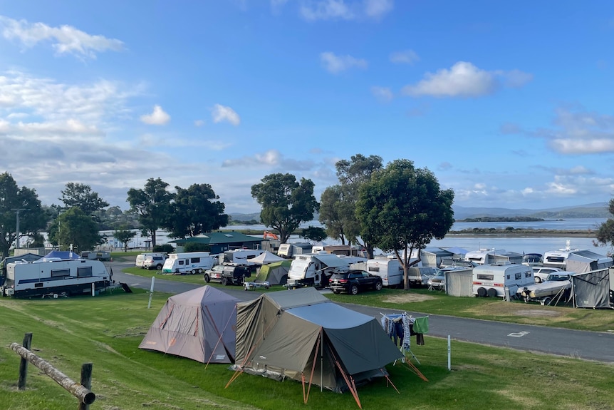 Caravans and tents parked along the foreshore of the inlet at Mallacoota   