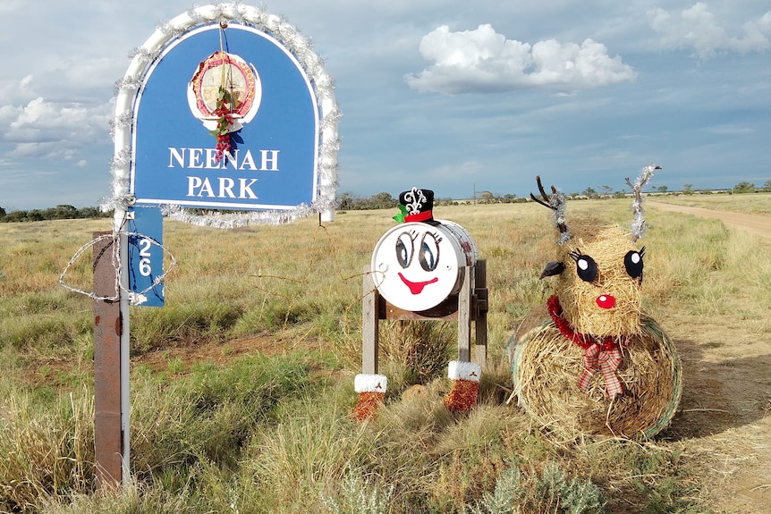 An outback mailbox northwest of Longreach has a santa face and a hay bale reindeer