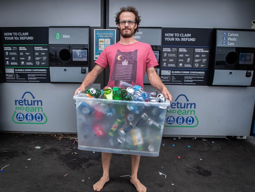 Simon Goldstein holds a crate for cans and bottles ready to refund at the container deposit scheme in Marrickville.