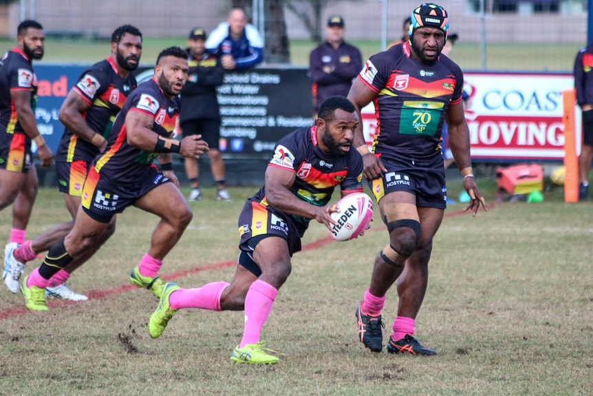 A rugby league player makes a run.