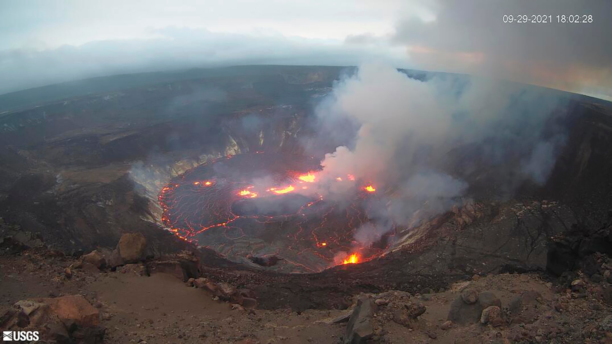 Gas clouds rise from a volcanic crater