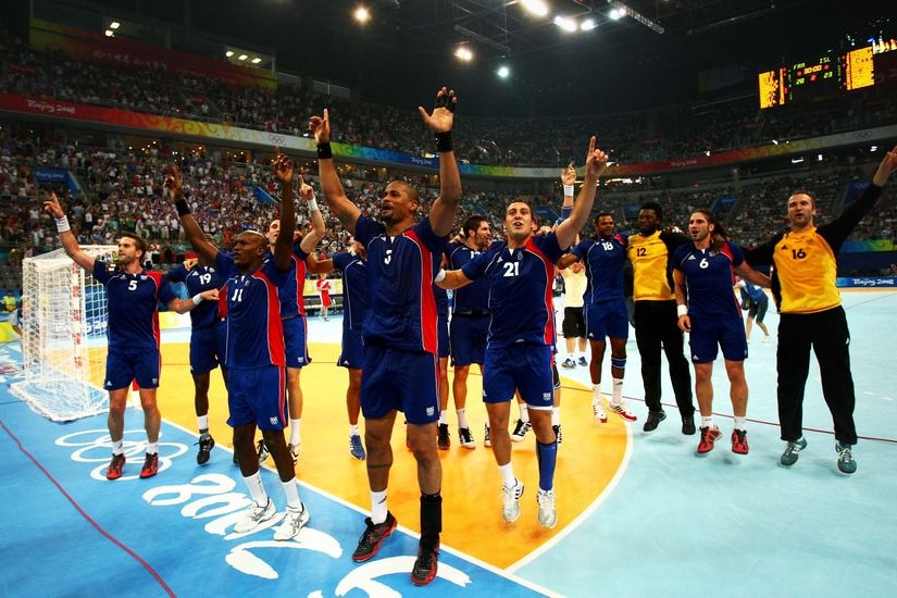 The French team celebrate winning the men's handball gold medal