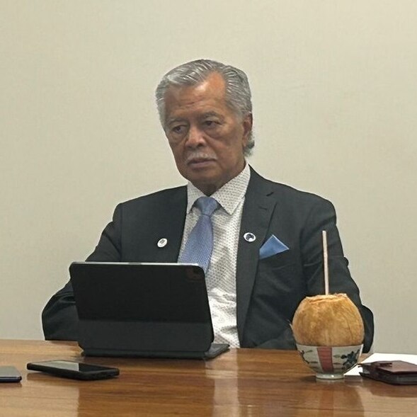 A man sitting at a laptop.