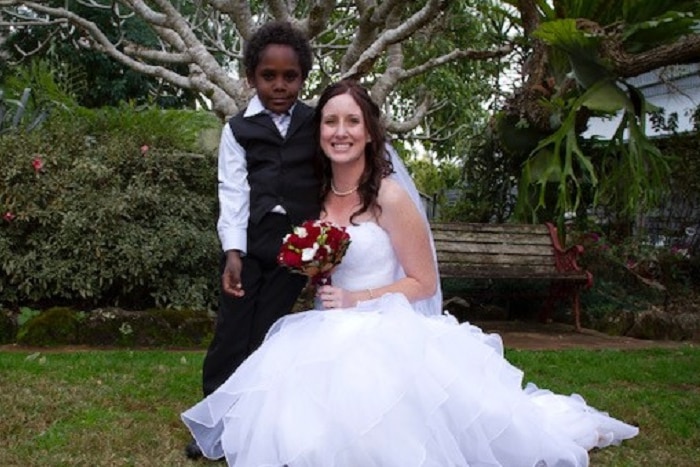 Charlie Chambers as a boy in formal wear with Renee Didlick in her wedding dress..
