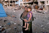 Palestinian woman returns to destroyed home in Gaza