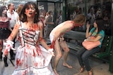 A woman sitting in a bus-stop photographs zombies
