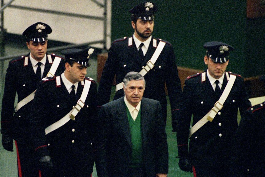 Mafia boss Toto Riina is escorted into the court house at Parlermo's Ucciardone prison in 1993.