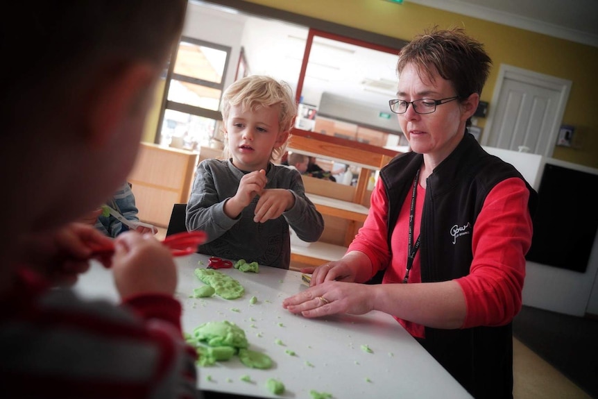 Jodie Hayes and child play with playdough.