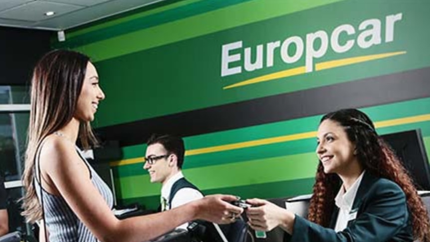 Female customer paying for car rental at Europcar office