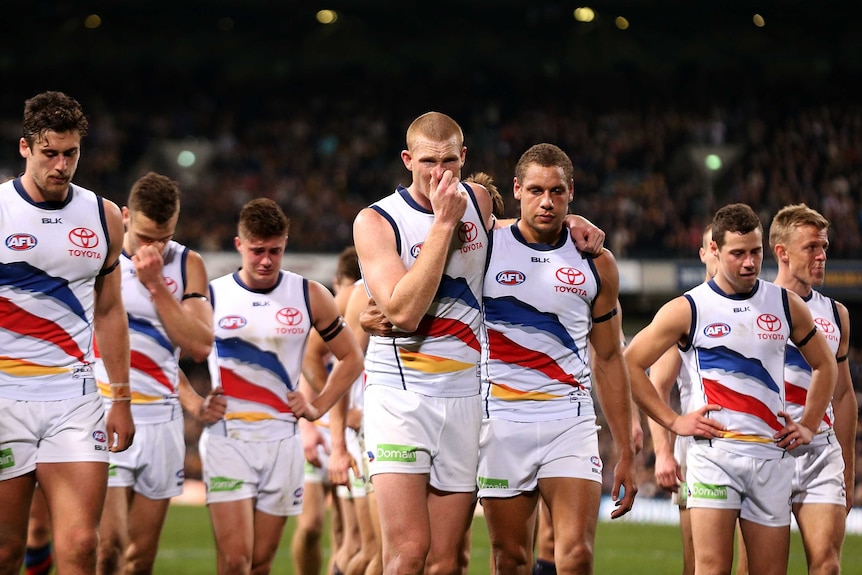 Valiant effort ... The Crows show their emotion as they leave the field
