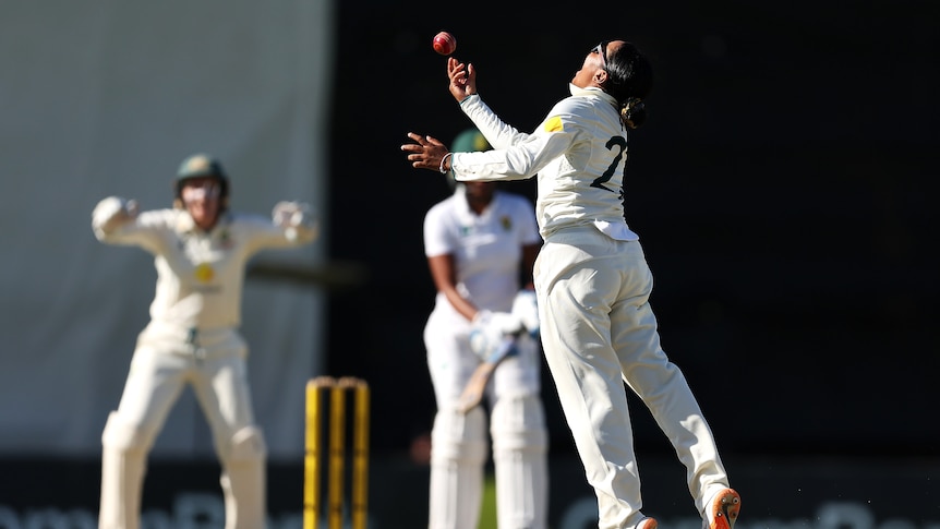 Australia bowler Alana King throws a ball in the air after winning a Test against South Africa.