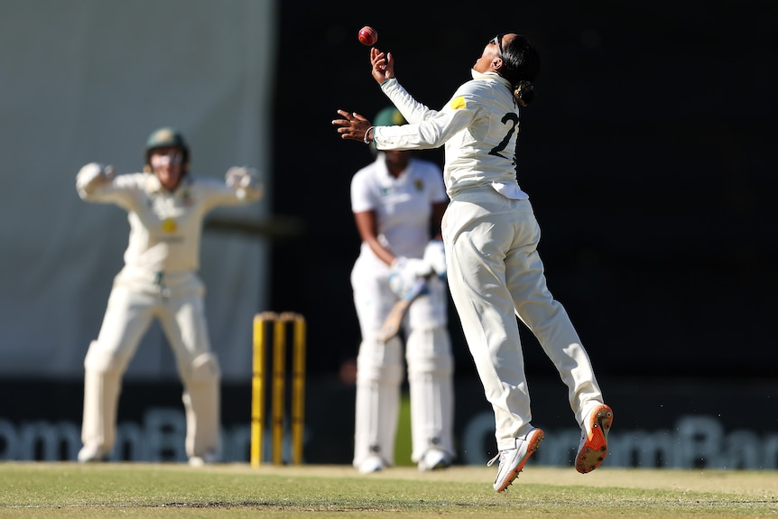 Australia bowler Alana King throws a ball in the air after winning a Test against South Africa.