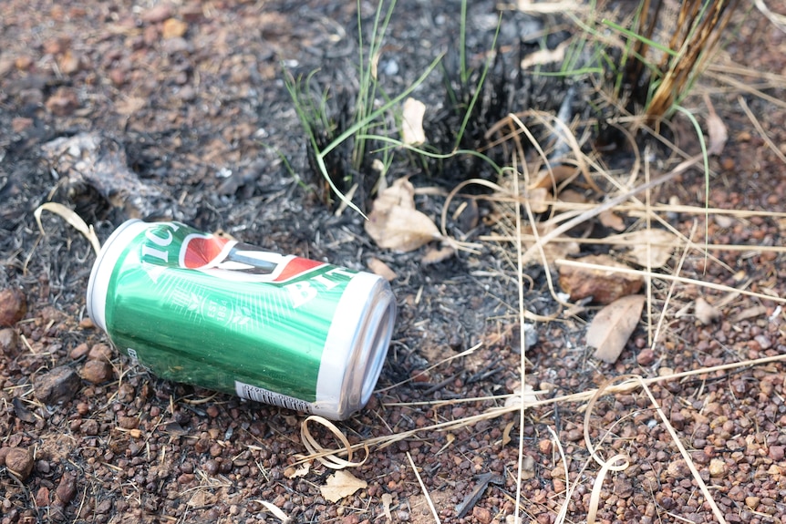 a VB beer can in dirt