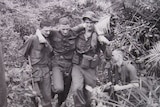 'Helping Hands' shows two soldiers assisting their mate out of the jungle after he was injured.