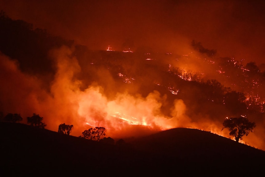 Nighttime view of the Dunn Road fire on January 10th in Mount Adrah, New South Wales, showing hills alight with fires.