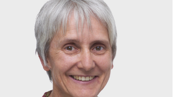 A picture of a woman with short grey hair, she is smiling.