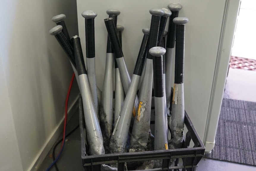 A crate of used metal bats are ready to be used in the smash room
