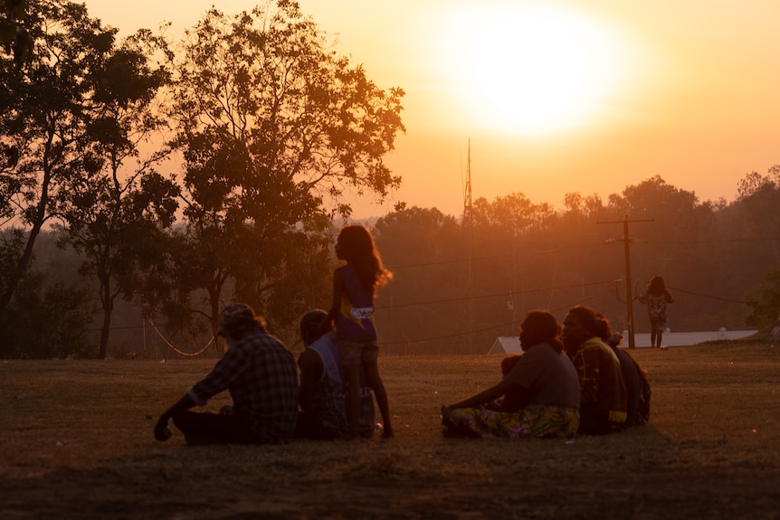 A group of people at sunset in Wadeye.