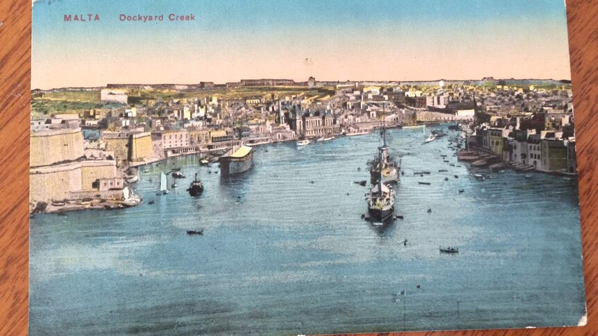 Old postcard with view of a harbour in Malta with ships and boats