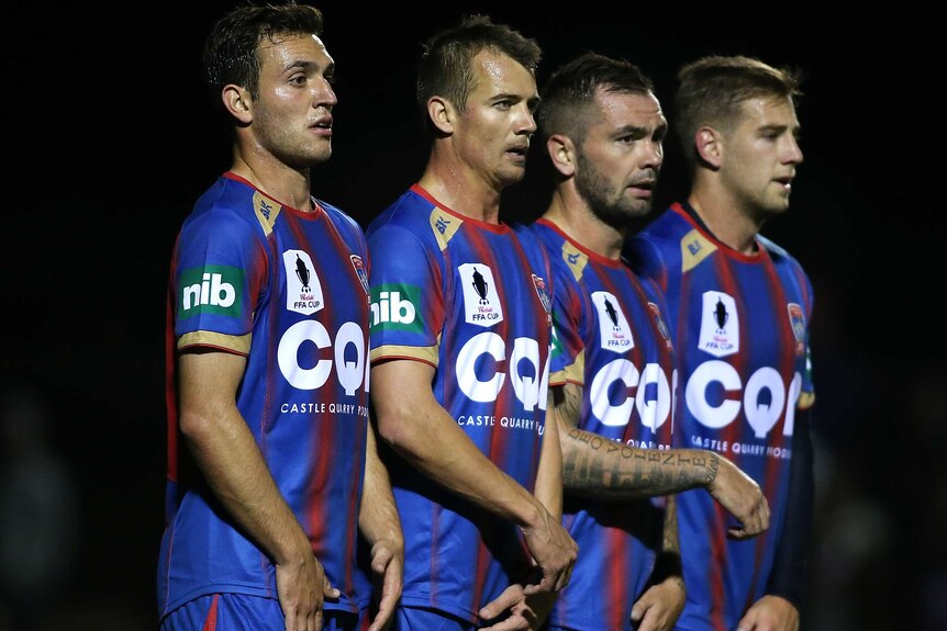 Newcastle Jets players line up to defend a free kick