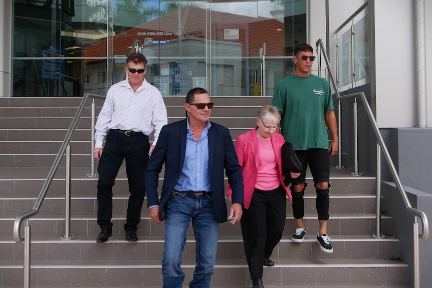 four people leave court house