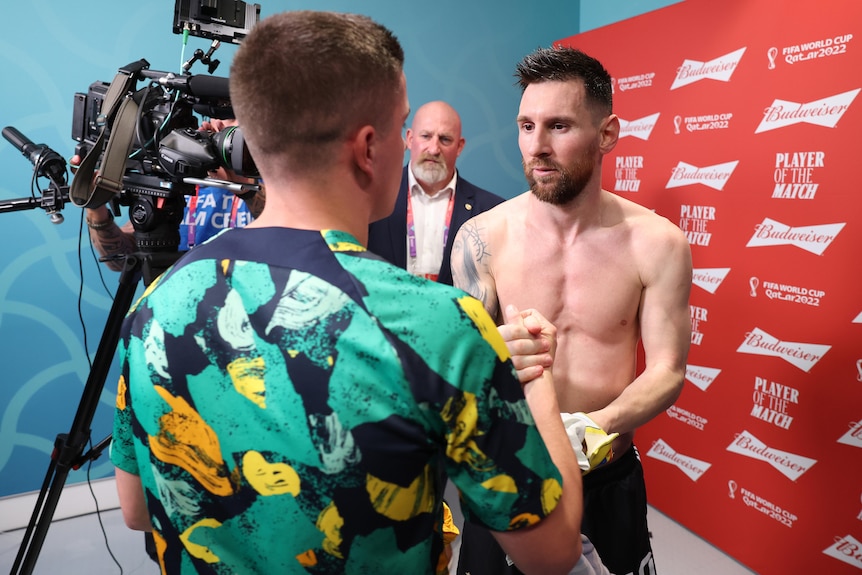 Two men swap jerseys after a soccer match