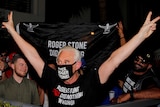 Roger Stone wearing a face mask that reads: Free Roger Stone.