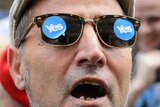 A man wearing Yes stickers on his glasses