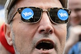 A man wearing Yes stickers on his glasses