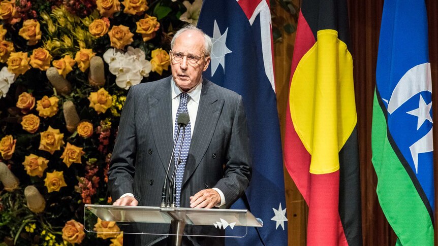 Former prime minister Paul Keating stands a podium giving a speech