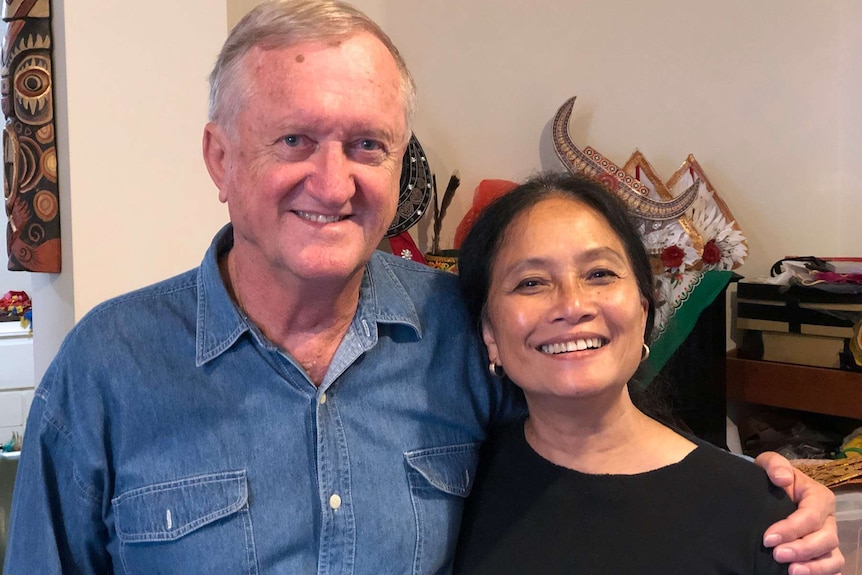 A mid shot of Richard and Astrid Onslow posing for a photo indoors.