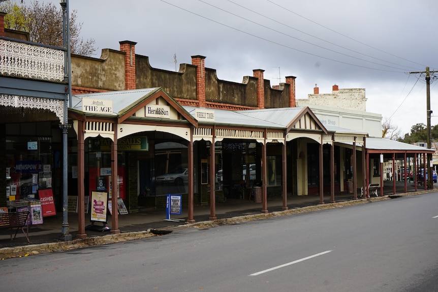 A street is lined with old 1860s wooden and brick buildings.