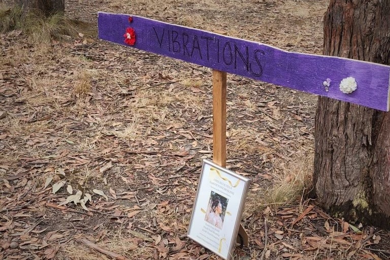Vibrations signage in bushland.