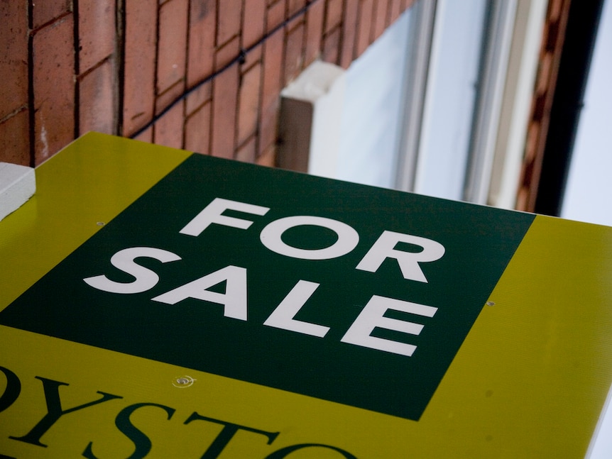 Close-up of a "for sale" sign