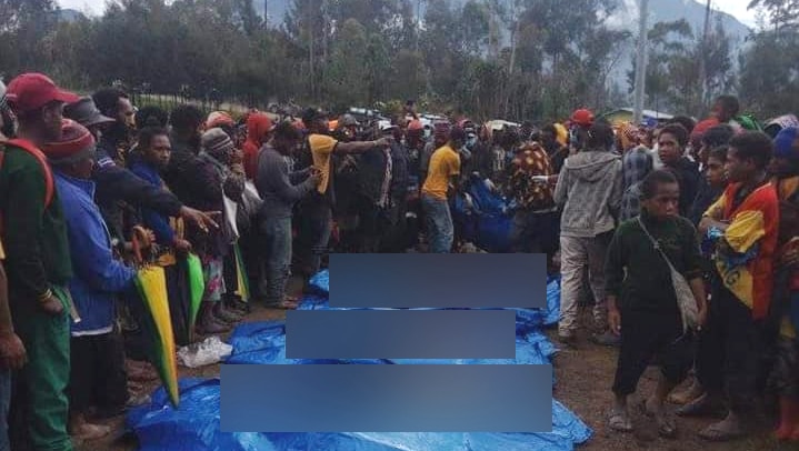 Victims of a massacre near Porgera township are laid out on tarps in PNG's Enga province.