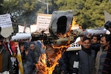 Indian students shout slogans as they burn an effigy of Indian spiritual guru Asharam.