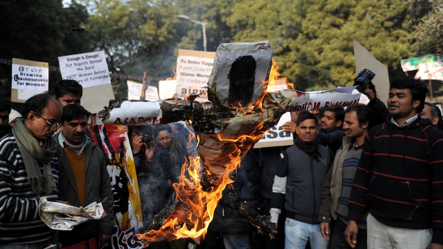 Indian students shout slogans as they burn an effigy of Indian spiritual guru Asharam.