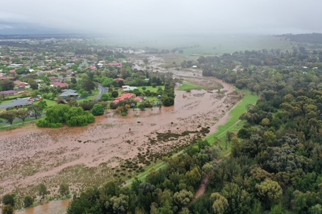 Drone photo of huge river next to houses