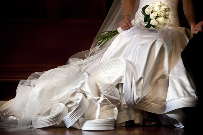 A picture of a wedding dress and flowers