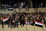 Protesters celebrate in the courtyard after breaking into Baghdad's Green Zone.