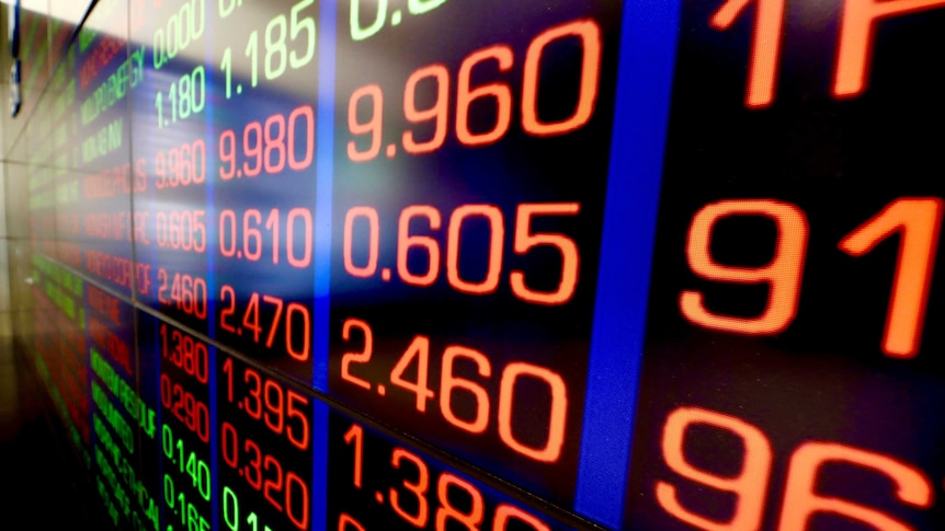 Giant screen on the wall of the ASX, with large red numbers, showing the price of shares which have fallen.